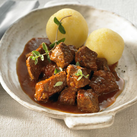 Eine Schüssel Gulasch vom Rind serviert mit Kartoffel Klößen | Klassisches Rindergulasch Rezept Klassisches Rindergulasch